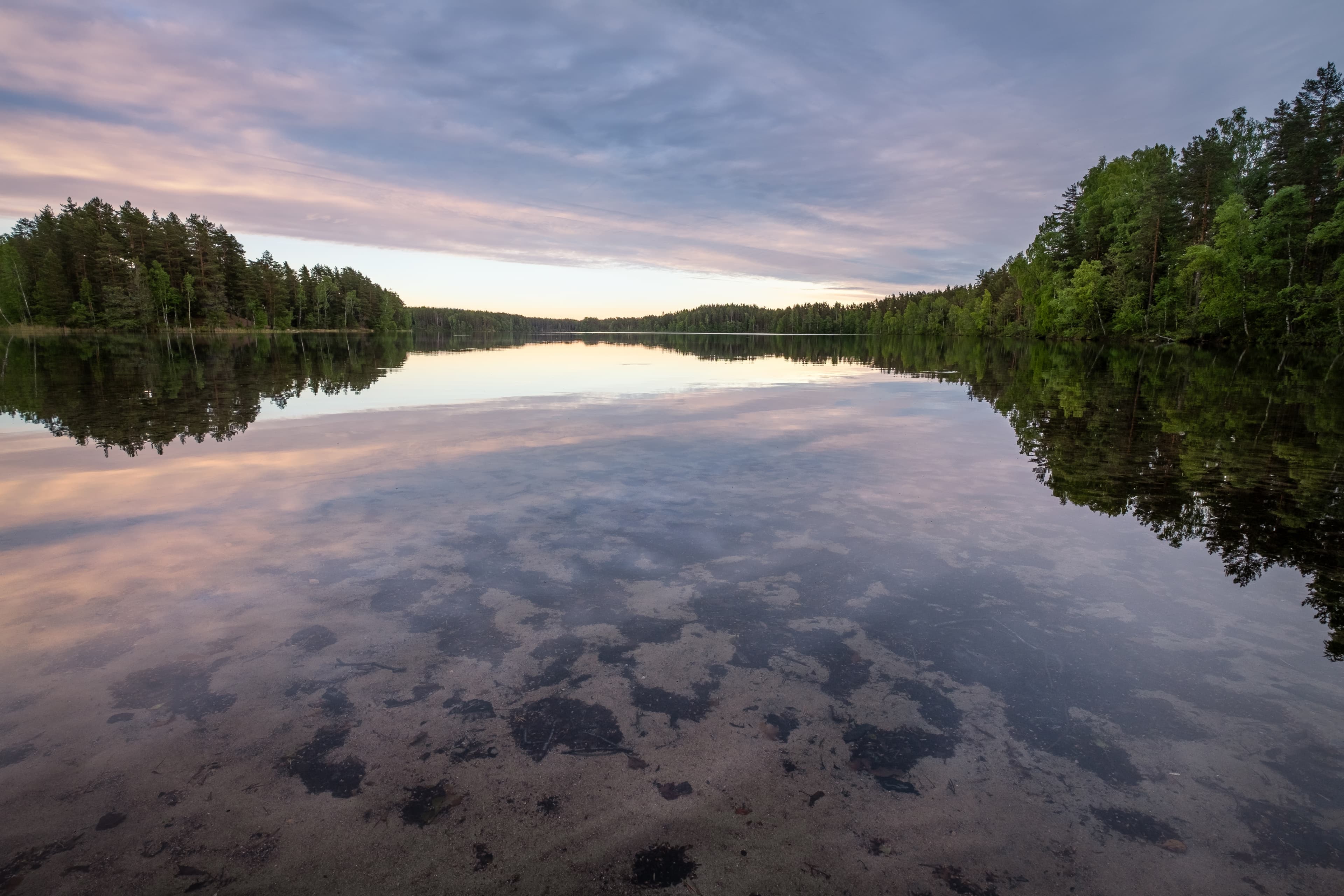 Scenic lake landscape with bright water and evening light at summer in Loppi, Finland Scenic lake landscape with bright water and evening light at summer in Loppi, Finland