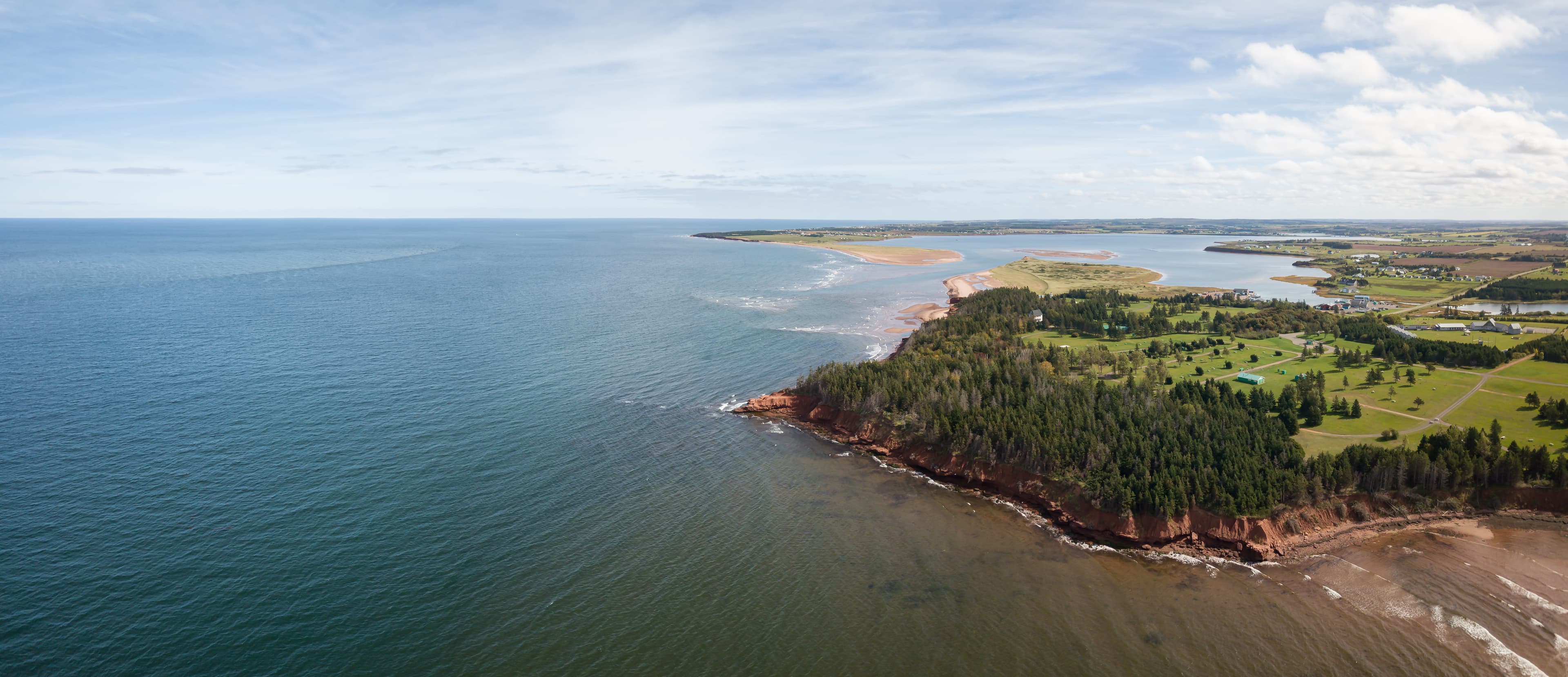 Aerial panoramic view of a beautiful rocky shore on the Atlantic Ocean. Taken in Cabot Beach Provincial Park, Prince Edward Island, Canada. Aerial panoramic view of a beautiful rocky shore on the Atlantic Ocean. Taken in Cabot Beach Provincial Park, Prince Edward Island, Canada.