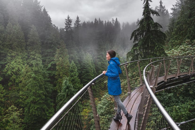 Canada Autumn travel destination in British Columbia. Asian tourist woman walking in famous attraction Capilano Suspension Bridge Park in North Vancouver, canadian vacation for tourism. Vancouver & North Vancouver Full-Day Tour 4