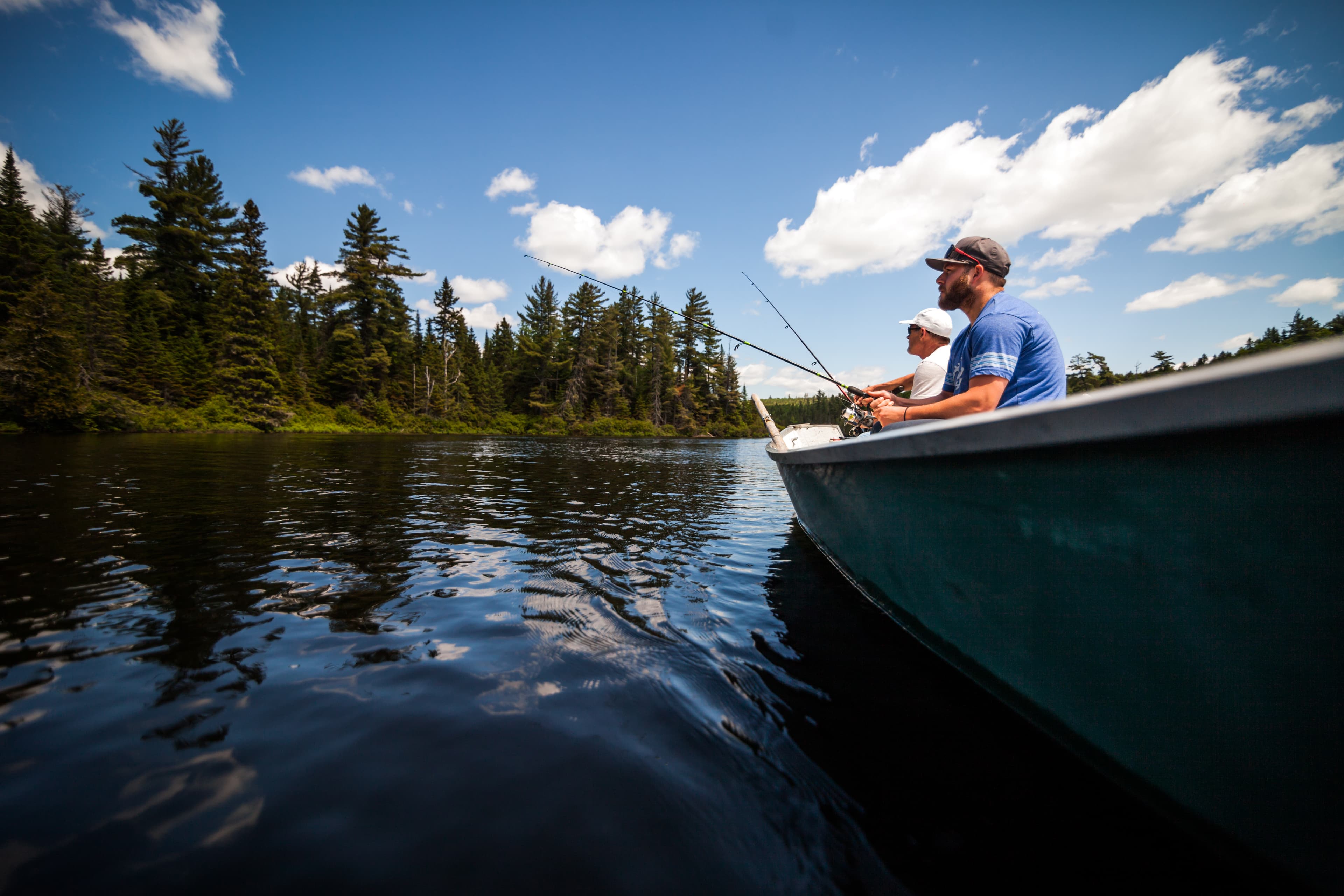 Sun and Father Fishing in a Calm Lake in Wild Nature from a Boat. Sun and Father Fishing in a Calm Lake in Wild Nature.