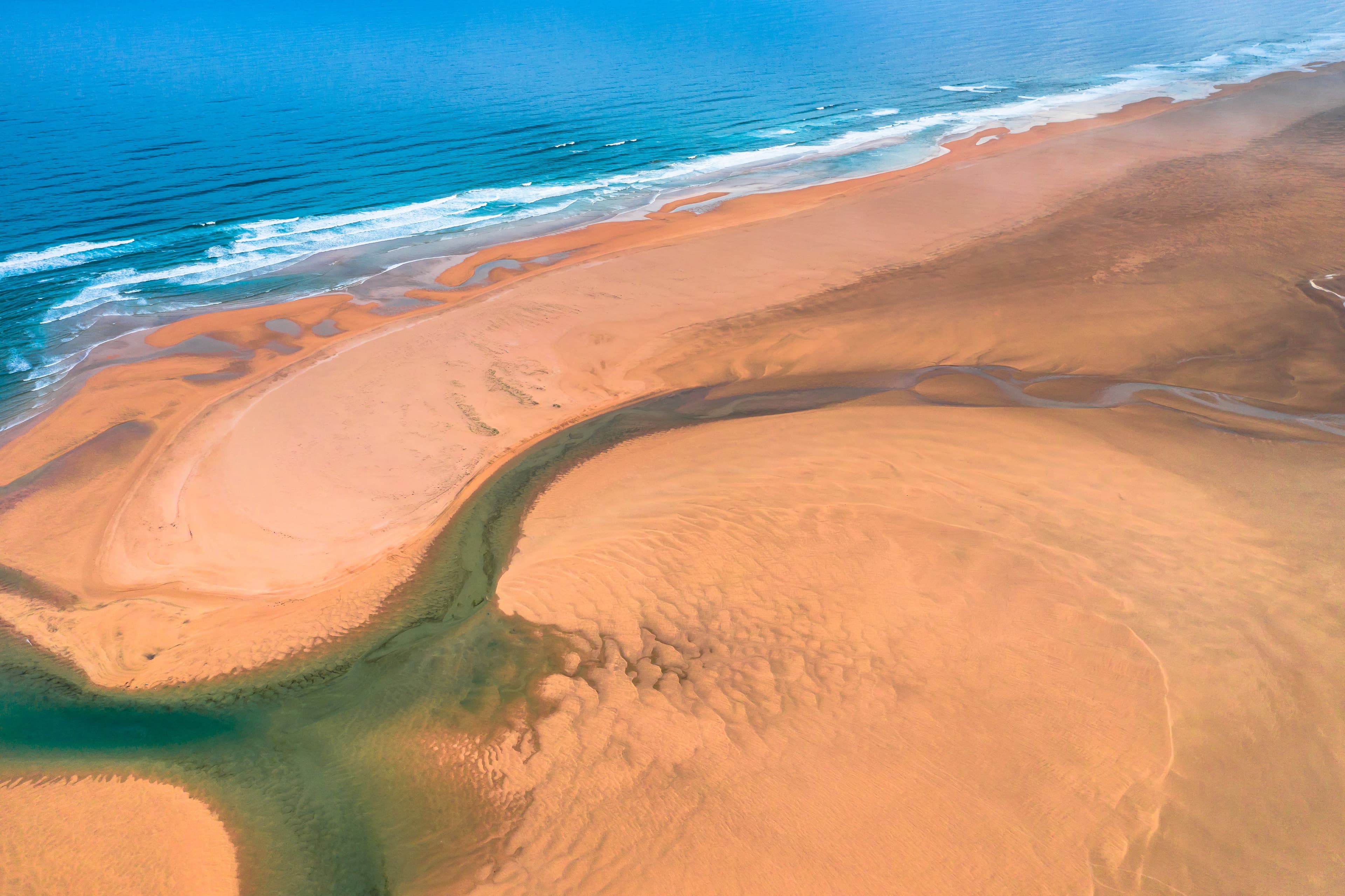 Aerial view of Raudasandur beach at the west fjords of Iceland Aerial drone view of icelandic Raudasandur beach with azure water streams and yellow sand