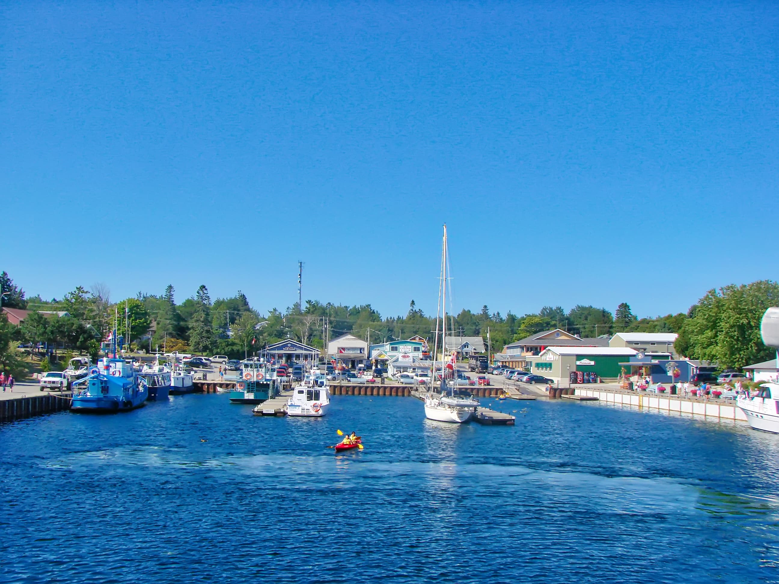 Tobermory, Ontario, Canada-1 July, 2017: Scenic Tobermory harbor, a departure point for boat tours to Huron lake, Manitoulin Island, sunset cruises and Fathom Five National Marine Park Tobermory, Ontario, Canada-1 July, 2017: Scenic Tobermory harbor, a departure point for boat tours to Huron lake, Manitoulin Island, sunset cruises and Fathom Five National Marine Park