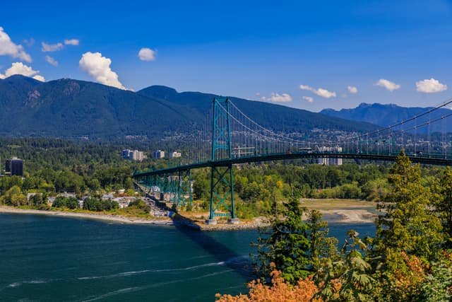 Lions Gate Suspension Bridge or First Narrows Bridge in Stanley Park Vancouver Canada with North Vancouver and mountains in the background Vancouver & North Vancouver Full-Day Tour 3