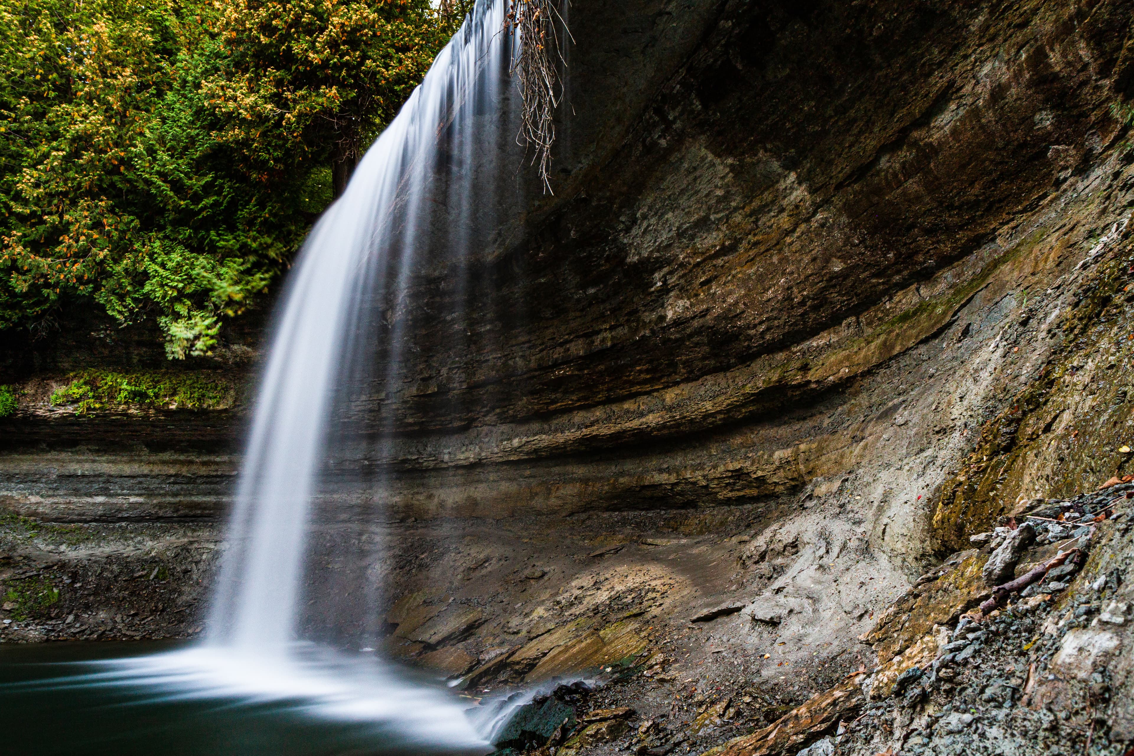 Stock Waterfall on Manitoulin Island in Ontario Canada at Sunset. Long time exposure of beautiful Bridal Veil Falls on Manitoulin Island surrounded bei trees and lake and ability to walk behind the falls.