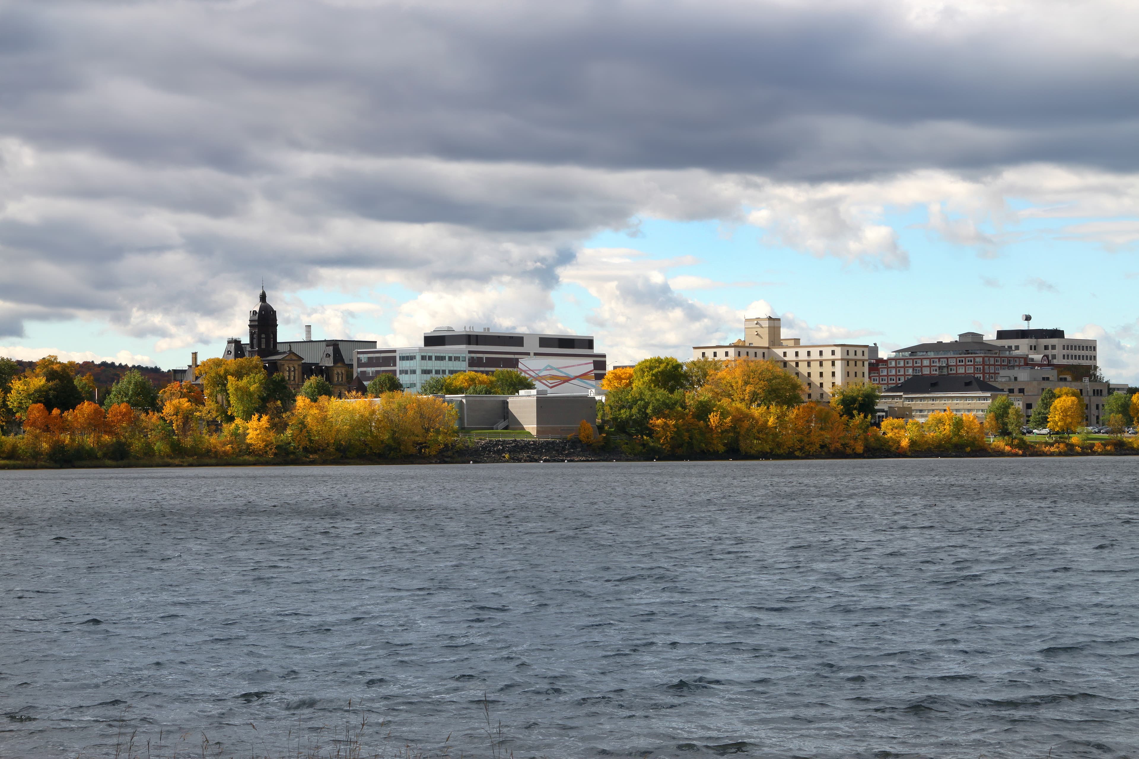 View  Fredericton, New Brunswick, along the Saint John River, Canada showing downtown buildings and  Fall foliage New Brunswick Region 04