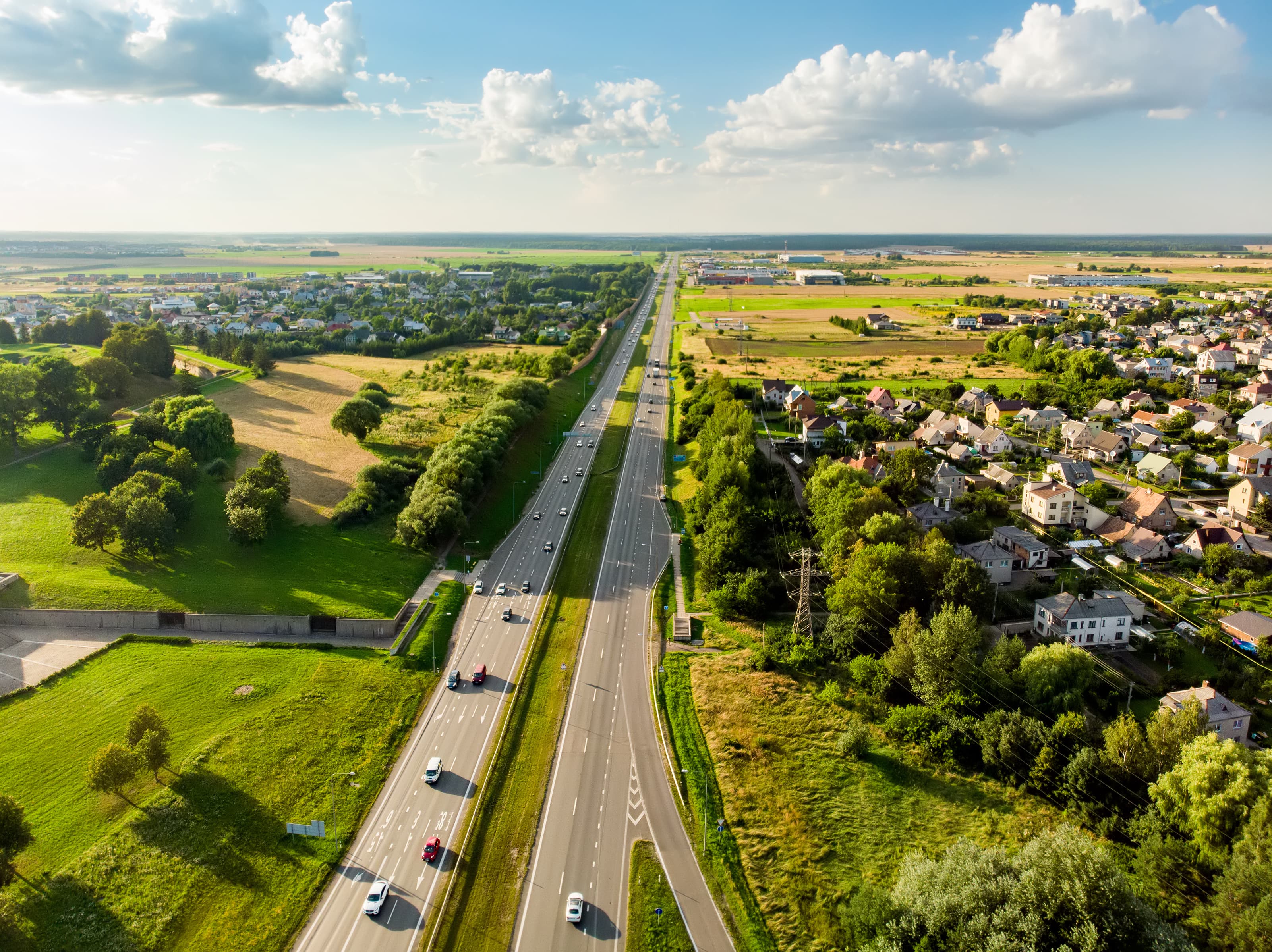 Aerial view of a highway road. Cars passing, highway junction, cross roads. Kaunas, Lithuania Aerial view of a highway road. Cars passing, highway junction, cross roads.
