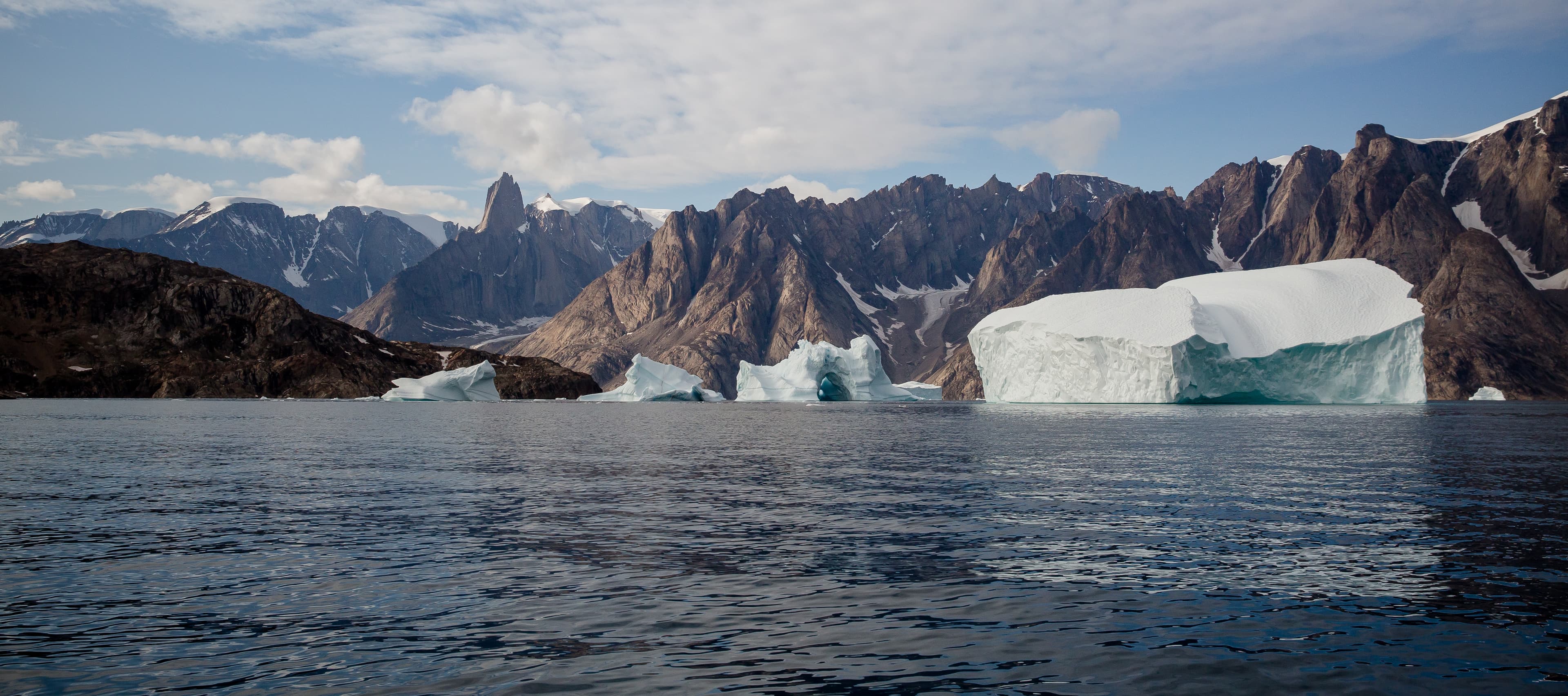arctic landscape with floating iceberg in the fjords of East Greenland in summer