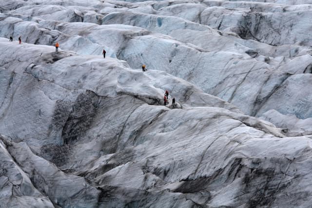 group-of-people-hiking-on-glacier-in-iceland